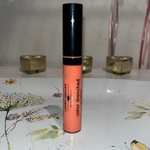 Laura Geller Color Drenched Lip Gloss in Melon Infusion firm